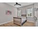 Bedroom with wood floors and a bed beneath windows with natural light at 570 Gandhi Dr, Lakeland, FL 33813