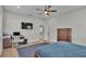Bedroom features a wooden dresser, work space with computer, ceiling fan and natural light at 570 Gandhi Dr, Lakeland, FL 33813