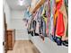 Walk-in closet with shelving, rods, and wood-look flooring, providing ample storage space at 570 Gandhi Dr, Lakeland, FL 33813