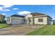 Attractive single-story home with a two-car garage and a well-maintained lawn at 570 Gandhi Dr, Lakeland, FL 33813