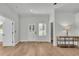 Bright living room featuring wood floors, white trim, a stylish console table, and lots of light at 570 Gandhi Dr, Lakeland, FL 33813