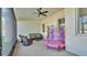 Covered patio with comfortable seating and a play area, perfect for outdoor relaxation at 570 Gandhi Dr, Lakeland, FL 33813