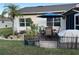 Landscaped backyard with patio, table, umbrella, landscaping rocks, plants, and palm tree at 5982 Crane Dr, Lakeland, FL 33809