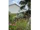 Scenic backyard with lush foliage, flowers, and an outdoor seating area at 5982 Crane Dr, Lakeland, FL 33809