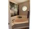 Bathroom features a soaking tub, decorative stained glass window, and neutral tones at 5982 Crane Dr, Lakeland, FL 33809