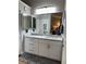 Bathroom features a new vanity, granite countertop, and decorative mirror at 5982 Crane Dr, Lakeland, FL 33809
