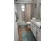 Bathroom featuring a tub with shower, white vanity, and blue mats at 5982 Crane Dr, Lakeland, FL 33809