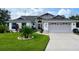 Charming single-story home with well-manicured lawn, landscaping, and a two-car garage at 5982 Crane Dr, Lakeland, FL 33809