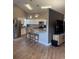 Bright kitchen features stainless steel appliances, wood floors, granite countertops, and white cabinets at 5982 Crane Dr, Lakeland, FL 33809