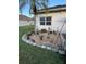 Charming landscape features a small palm tree and gravel surrounded by flowers at 5982 Crane Dr, Lakeland, FL 33809