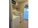 Laundry room with washer, dryer, overhead storage and access to the garage at 5982 Crane Dr, Lakeland, FL 33809