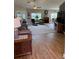 Bright, open-concept living room with hardwood floors, fireplace, and comfortable seating arrangement at 5982 Crane Dr, Lakeland, FL 33809