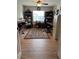 Well-lit home office space with built-in desk, hardwood floors, rug, and shelving units flanking a window at 5982 Crane Dr, Lakeland, FL 33809