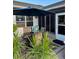 Outdoor patio area with table, umbrella, seating and view of the surrounding landscaping at 5982 Crane Dr, Lakeland, FL 33809