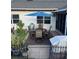 Outdoor patio area with table, umbrella, seating, fence, and view of the side yard at 5982 Crane Dr, Lakeland, FL 33809