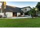 Backyard view of a pool and patio surrounded by a large lawn at 1215 Cypress E Pt, Winter Haven, FL 33884