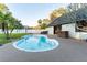 Backyard swimming pool with concrete deck and mature trees; includes a hot tub at 1215 Cypress E Pt, Winter Haven, FL 33884