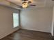 Bright bedroom with wood-look floors and large window at 1271 Groveland Ln, Lakeland, FL 33811