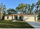 Charming single-story home with a well-maintained lawn and a two-car garage at 1271 Groveland Ln, Lakeland, FL 33811