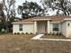 Front view of a house with walkway and landscaping at 1271 Groveland Ln, Lakeland, FL 33811