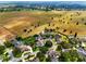 Wonderful aerial view showcasing the property's location nestled between lush greenery and large agricultural fields at 1935 Austin Ter, Winter Haven, FL 33884