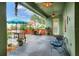 A covered patio features comfortable seating and tranquil views of outdoor landscaping and patio furniture at 1935 Austin Ter, Winter Haven, FL 33884