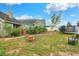Landscaped backyard featuring a wooden archway, bench, and a trampoline, creating a Gathering-friendly outdoor space at 1935 Austin Ter, Winter Haven, FL 33884