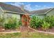 Landscaped backyard featuring a wooden archway, a variety of tropical plants and mulch ground covering at 1935 Austin Ter, Winter Haven, FL 33884