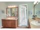 Bathroom boasting double sinks, a large mirror, and access to an outdoor patio at 1935 Austin Ter, Winter Haven, FL 33884