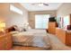 Cozy bedroom with a queen bed, natural light, and wood furnishings at 1935 Austin Ter, Winter Haven, FL 33884