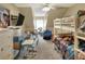 Bedroom with carpet, a bunk bed, and a desk with an office chair and wall mounted television on the wall at 1935 Austin Ter, Winter Haven, FL 33884