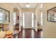 Inviting entryway with hardwood floors, a white front door, and sidelights that flood the space with natural light at 1935 Austin Ter, Winter Haven, FL 33884