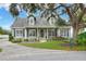 Charming two-story home featuring a mature shade tree, well-maintained landscaping, and a welcoming front porch at 1935 Austin Ter, Winter Haven, FL 33884