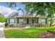 Charming two-story home with a well-maintained lawn, complemented by lush landscaping and mature trees at 1935 Austin Ter, Winter Haven, FL 33884
