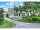 Well-maintained home featuring lush landscaping and a mature shade tree in a residential neighborhood at 1935 Austin Ter, Winter Haven, FL 33884