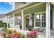 Inviting home featuring a covered front porch with decorative columns, outdoor seating, and colorful landscaping at 1935 Austin Ter, Winter Haven, FL 33884