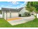 Spacious three-car garage and basketball hoop on driveway, providing parking and recreational space at 1935 Austin Ter, Winter Haven, FL 33884