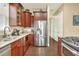 Spacious kitchen featuring stainless steel appliances, granite countertops, and dark wood cabinets at 1935 Austin Ter, Winter Haven, FL 33884
