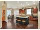 Gourmet kitchen with a large island, dark cabinets, granite countertops, and stainless steel appliances at 1935 Austin Ter, Winter Haven, FL 33884