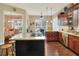 Bright kitchen with dark wood cabinets, granite countertops and stainless appliances at 1935 Austin Ter, Winter Haven, FL 33884