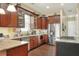 Well-appointed kitchen features stainless steel appliances, granite countertops, and custom wood cabinetry for a modern look at 1935 Austin Ter, Winter Haven, FL 33884