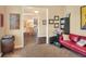 Inviting living room leading into the dining area, complete with hardwood floors and walls adorned with eclectic art at 1935 Austin Ter, Winter Haven, FL 33884