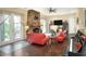 Living room with a brick fireplace, red sofas, and wood flooring at 1935 Austin Ter, Winter Haven, FL 33884