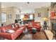 Open living room with wood floors, brick fireplace, and kitchen in the background at 1935 Austin Ter, Winter Haven, FL 33884