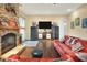 Cozy living room with brick fireplace, entertainment center, and wood floors at 1935 Austin Ter, Winter Haven, FL 33884
