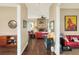 Open-concept living room featuring a stone fireplace, hardwood floors, and neutral walls for a warm and inviting atmosphere at 1935 Austin Ter, Winter Haven, FL 33884