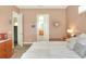 Cozy bedroom featuring a decorative starburst mirror, plush bedding, and en-suite bathroom entrance at 1935 Austin Ter, Winter Haven, FL 33884