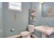 Powder room featuring decorative shelves, a window, and a pedestal sink with modern fixtures at 1935 Austin Ter, Winter Haven, FL 33884