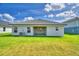 A house with a grey tile roof and a well-maintained green backyard at 4688 Grandview Glen Dr, Auburndale, FL 33823