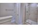 Bathroom with neutral paint, tiled walk-in shower with glass door, and nickel hardware at 4688 Grandview Glen Dr, Auburndale, FL 33823